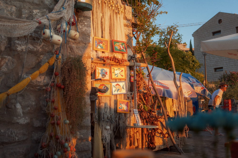 The same wall of nets and tiles, a terrace behind it