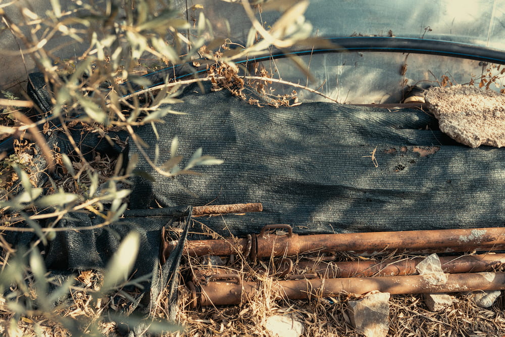 Dry branches piled on black sheeting