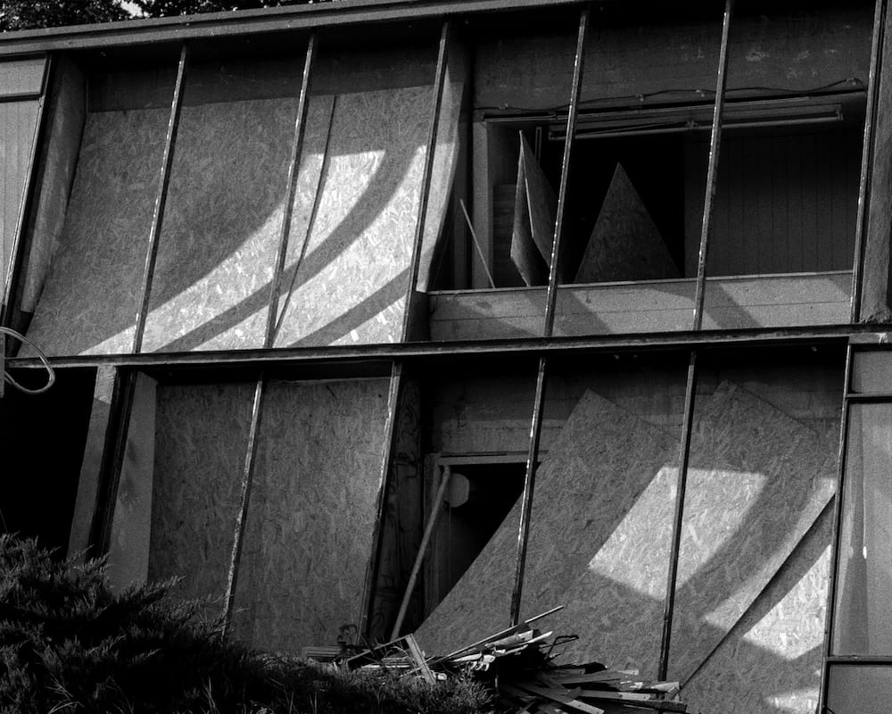 Black and white: boarded-up windows on a modernist building