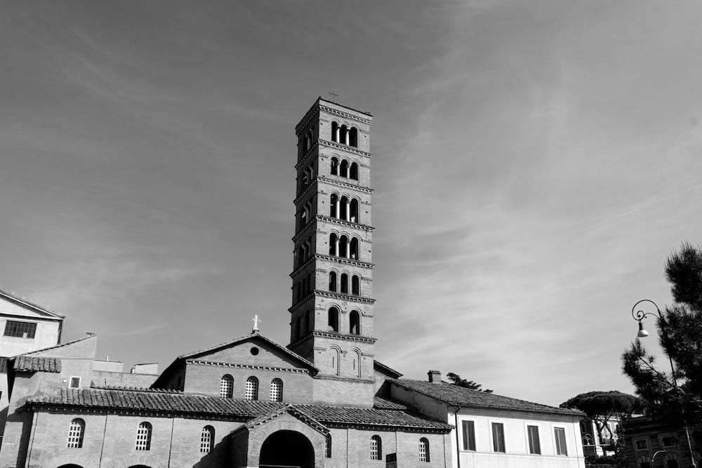 Black and white: a brick bell tower above a church front.