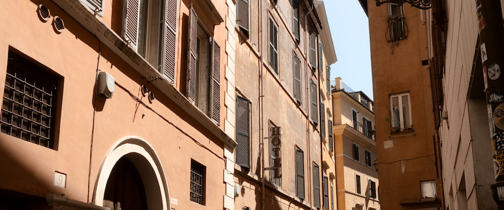 A street of ochre buildings with an arched doorway, wide.