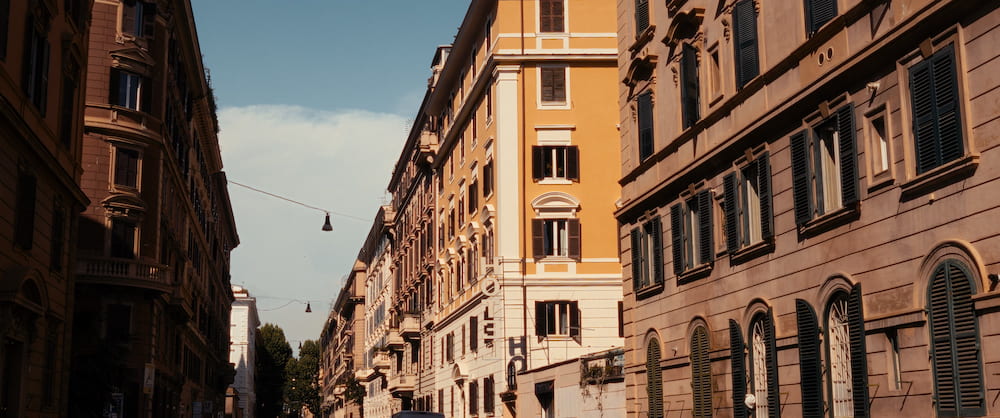 A street between ochre and red buildings, wide.