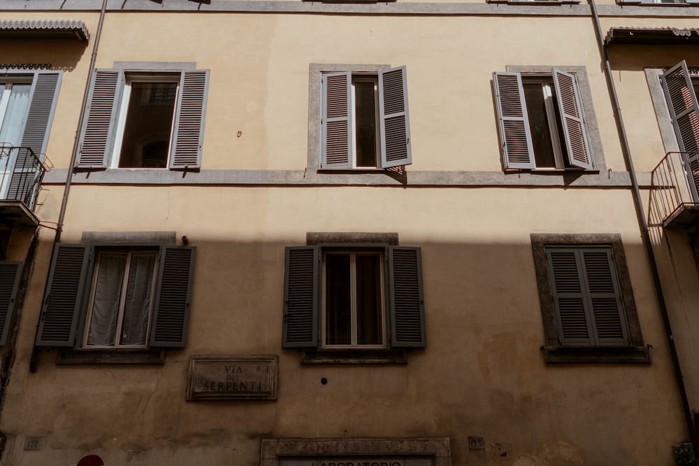A pale building front with shutters, straight on.