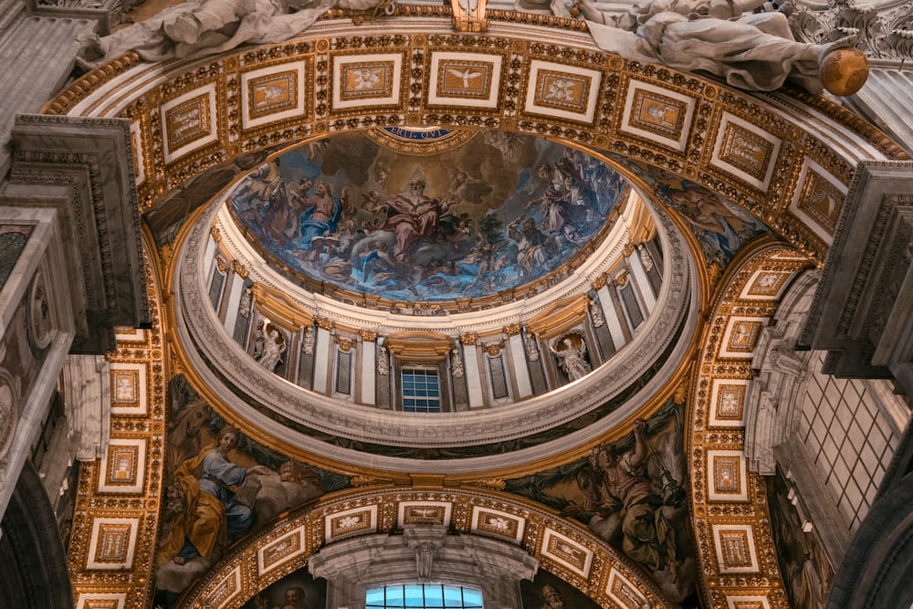 The inside of a dome, gilded coffers around it.
